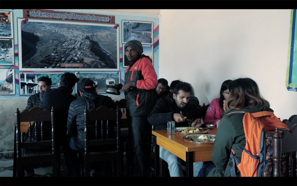 Binod Pariyar 'Belly' serving food to customers in hotel