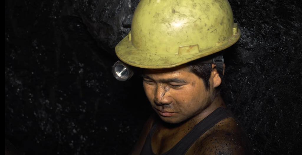 Story of Coal Mines - Picture shows a young miner inside a coal mine  