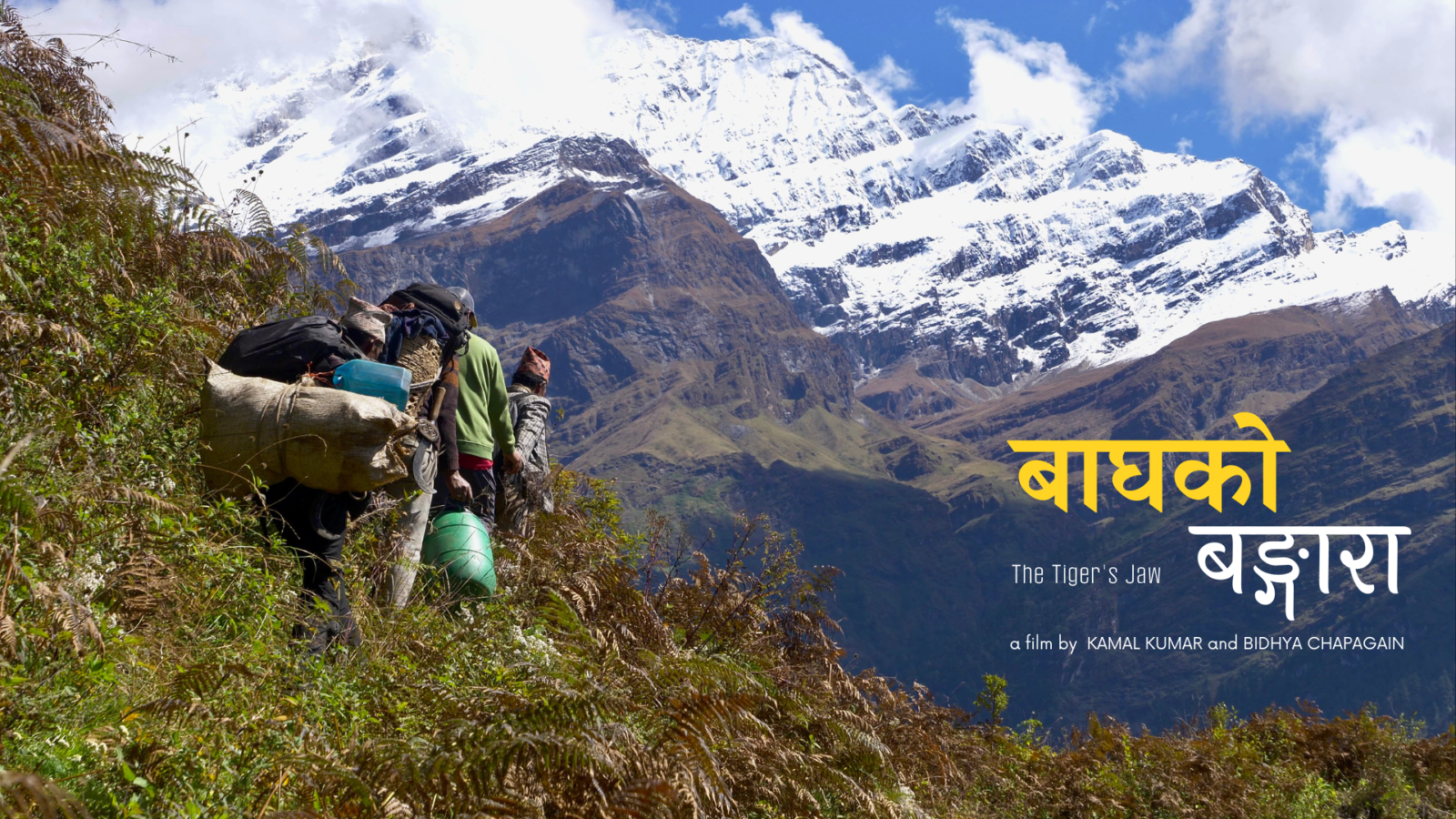 men walking away from the camera against a majestic backdrop of mountains